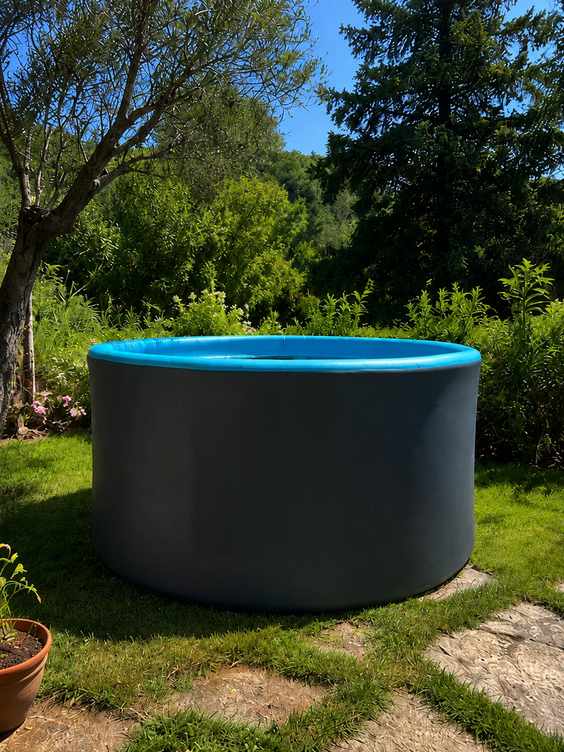 Photograph of the Hippool Circle pool set up on grass in a garden, seen in daylight beside a stone path